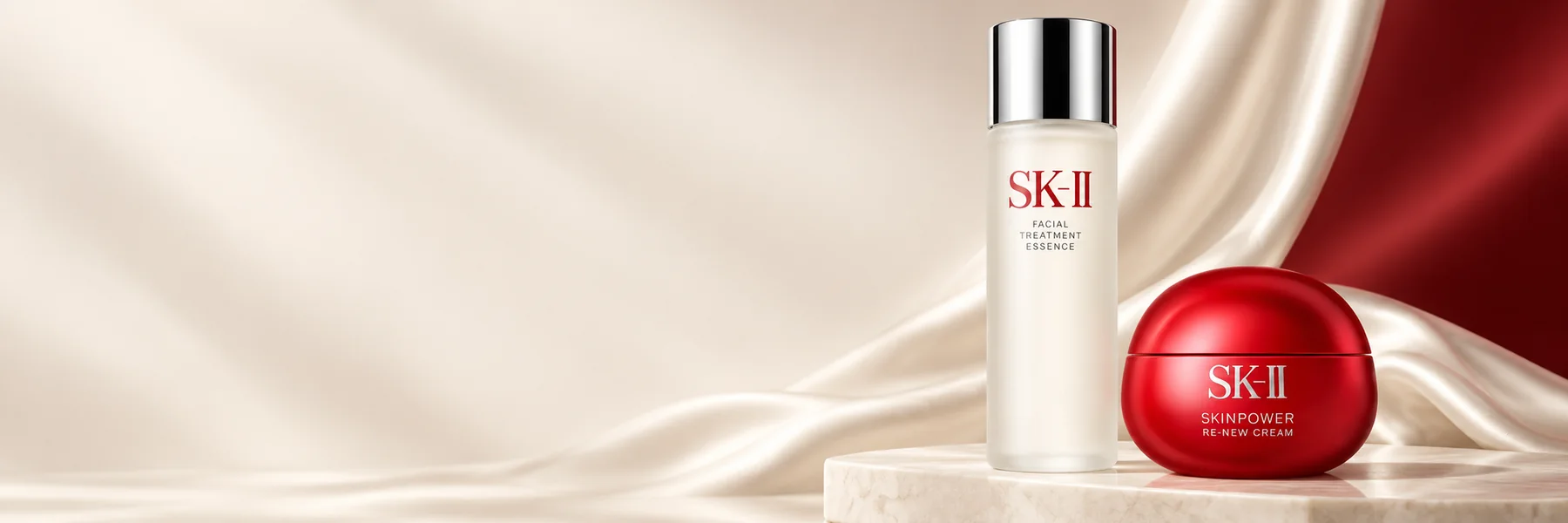 SK-II Facial Treatment Essence and SKINPOWER Re-New Cream on ivory stone
